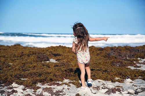 Girl plays on beach